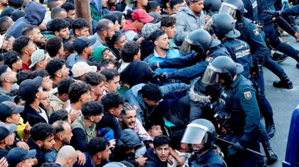 Police fire shots in the air as thousands of migrants moved from Ceuta beaches